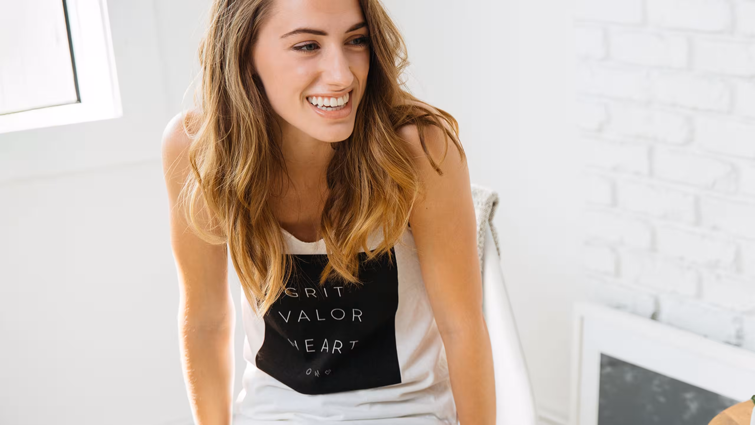 women wearing a white sleeveless shirt with a large black design on the front