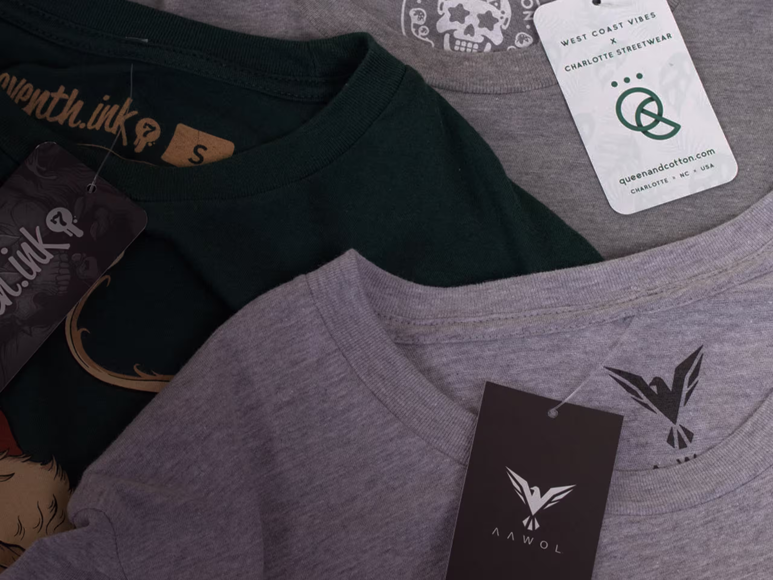 several t-shirts laying flat with hang tags