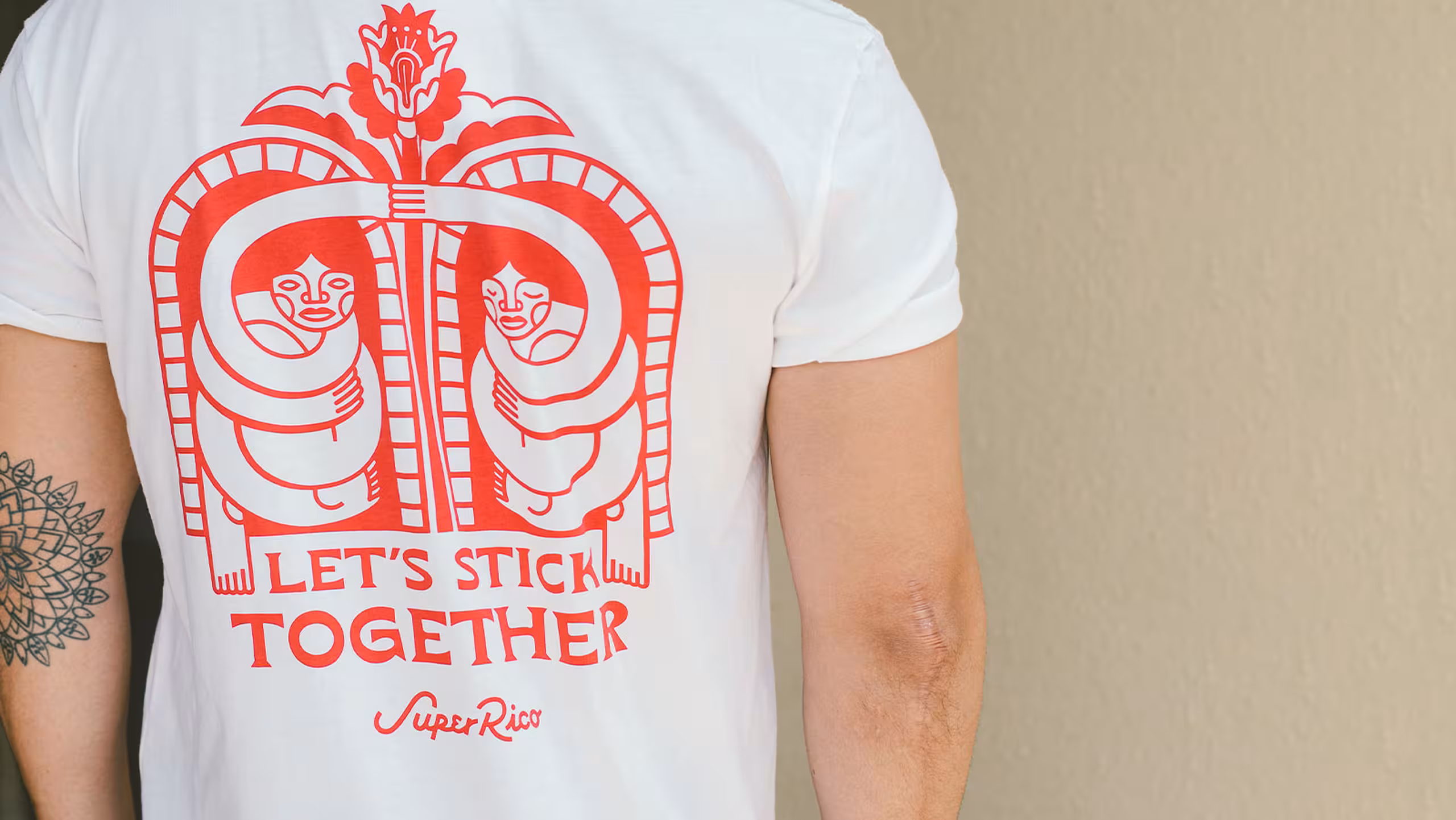 back of a man wearing a white shirt with red imprint design