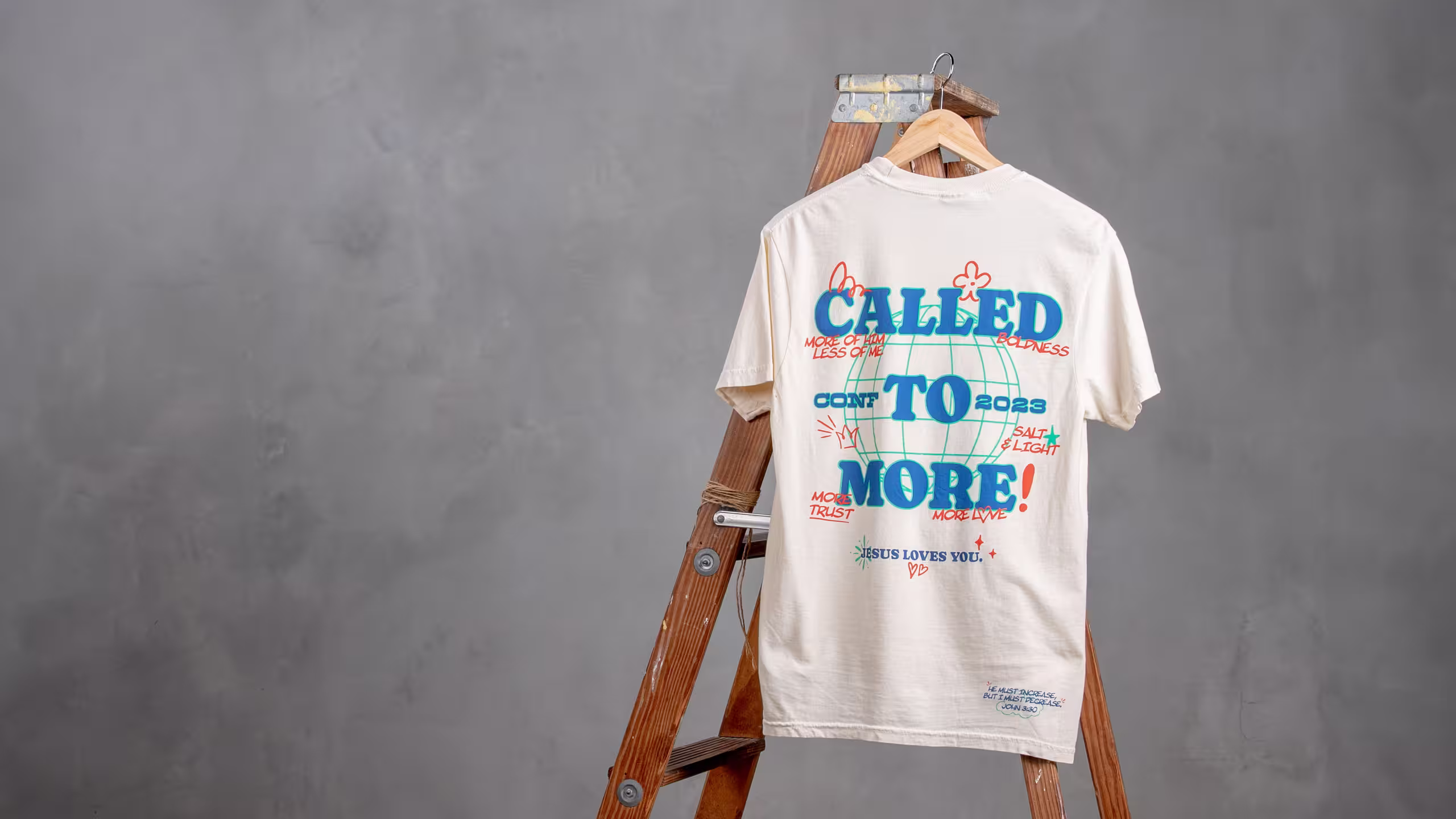 white t-shirt hanging on a ladder
