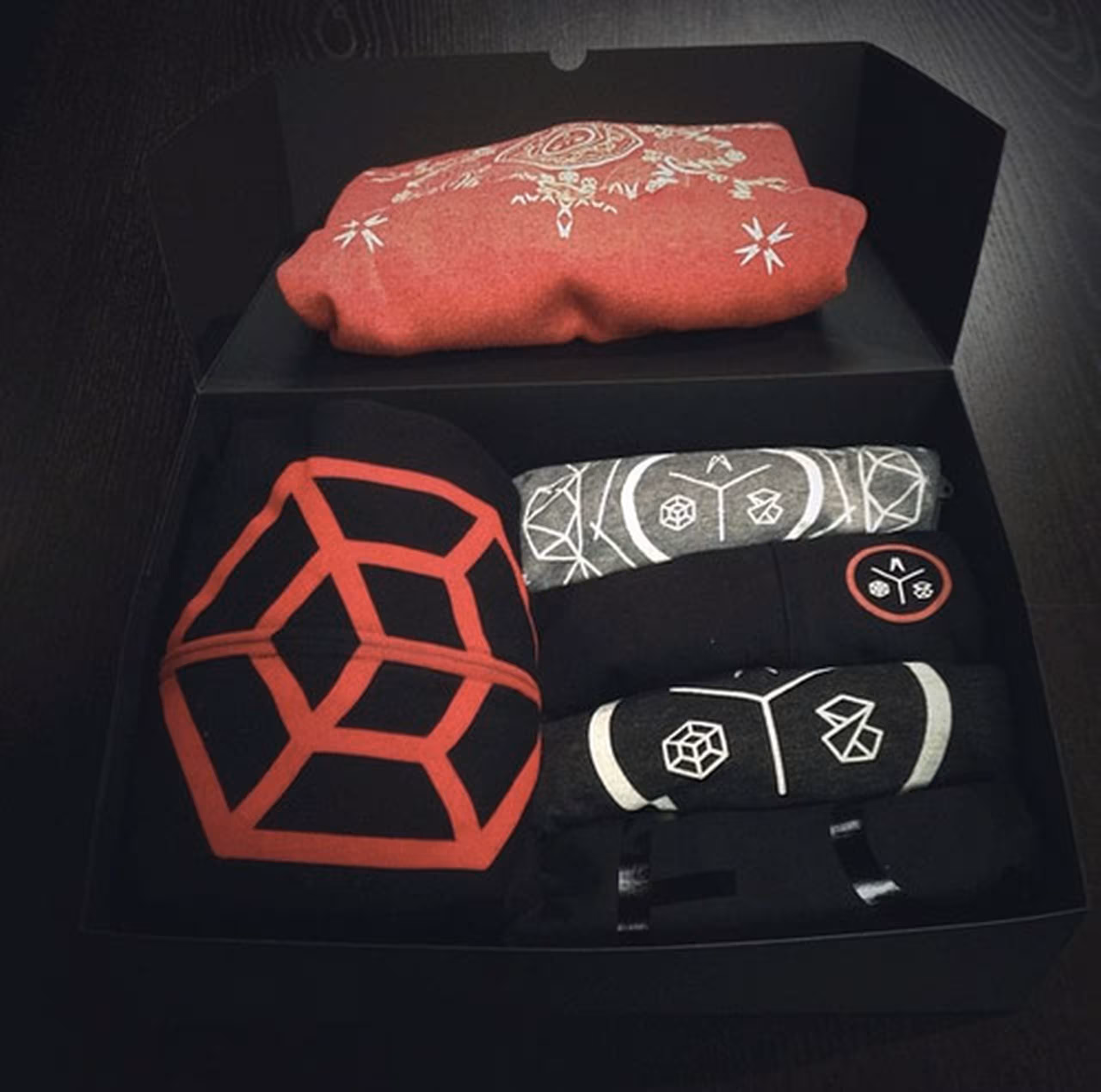 merch box with zip-up hoodie and t-shirts