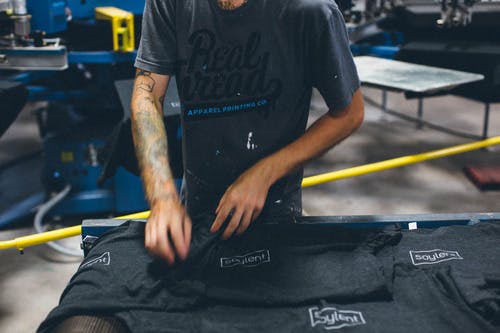 t-shirts being folded t-shirts being folded